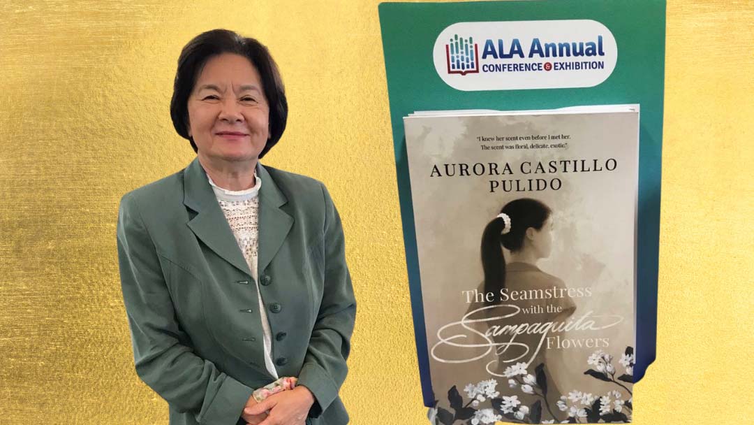 Aurora Pulido standing beside a promotional poster of her book